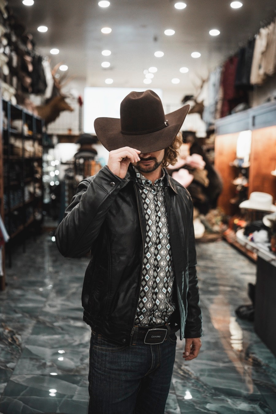 Leather jacket and felt hat in store
